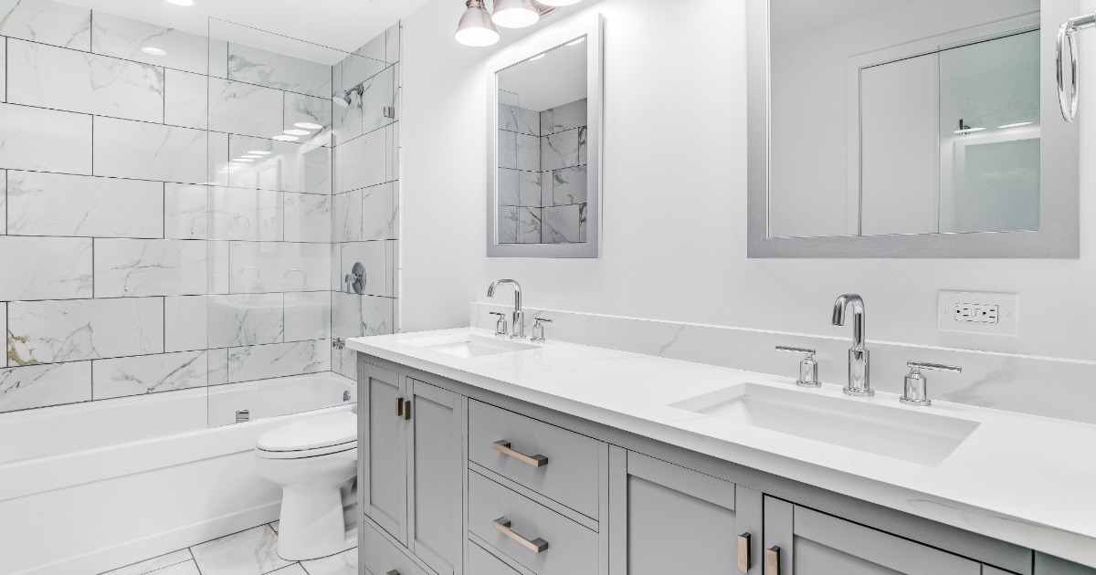 Homeowner planning a bathroom renovation by reviewing design samples, notes, and project decisions