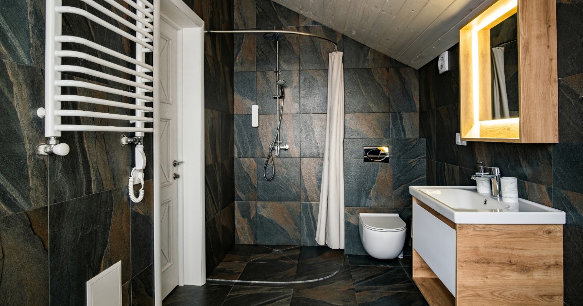 Bathroom renovation with premium features including frameless glass shower, freestanding tub, and double vanity