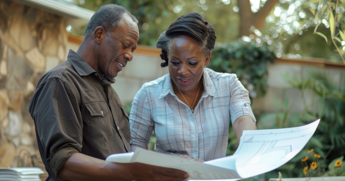 Homeowner planning a kitchen renovation by reviewing layout plans, material samples, and project decisions