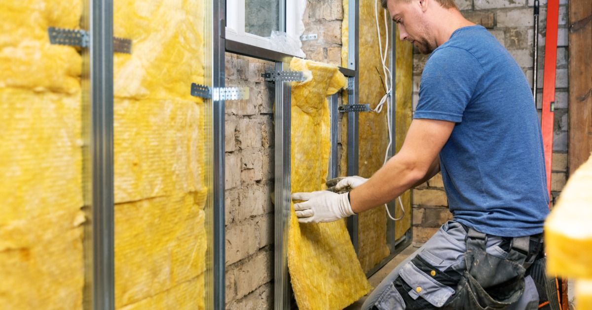Contractors coordinating framing, electrical, drywall, and finish work during a basement renovation